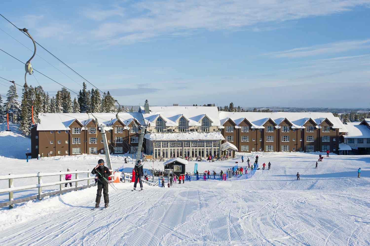 Stöten in Sweden - a group of people skiing down a snow covered hill.