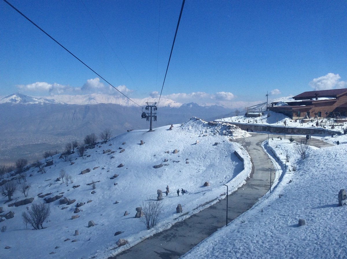 Korek Mountain Resort in Iraq - a ski lift going up a snowy mountain.