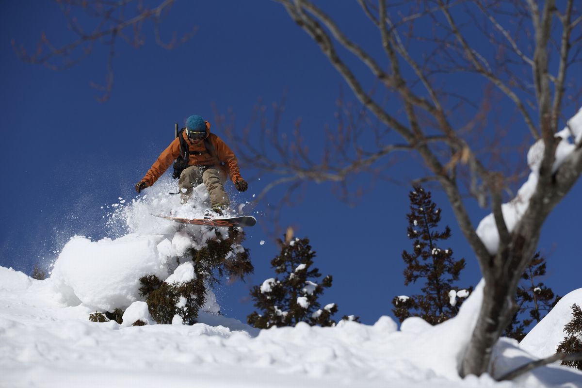 Wakabuna Kogen in Japan - a man riding a snowboard down a snowy slope.