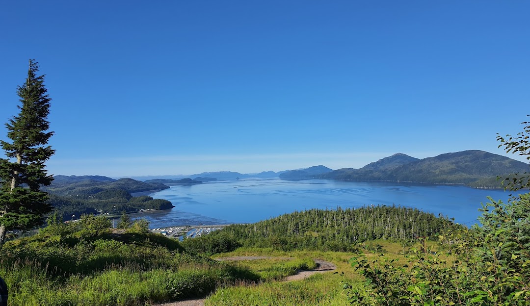 Mt Eyak Ski Area in USA - a view from the top of a mountain with a lake in the distance.