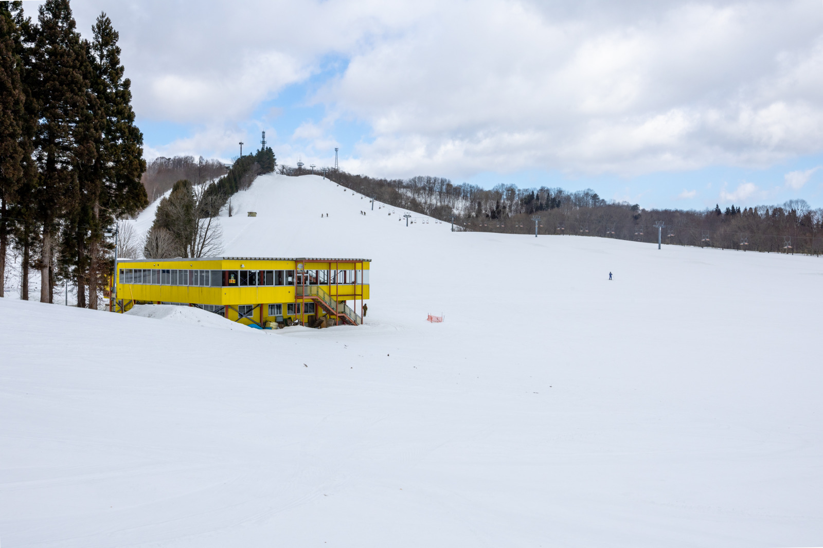 Mikata Snow Park in Japan - a yellow bus is parked in the snow.