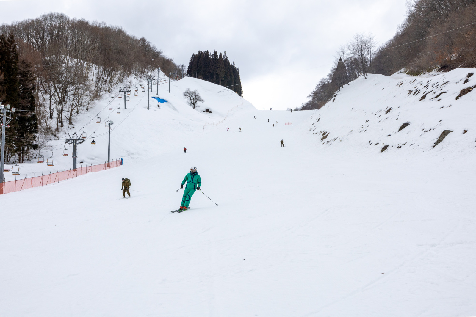 Mikata Snow Park in Japan - a group of people skiing down a snowy hill.