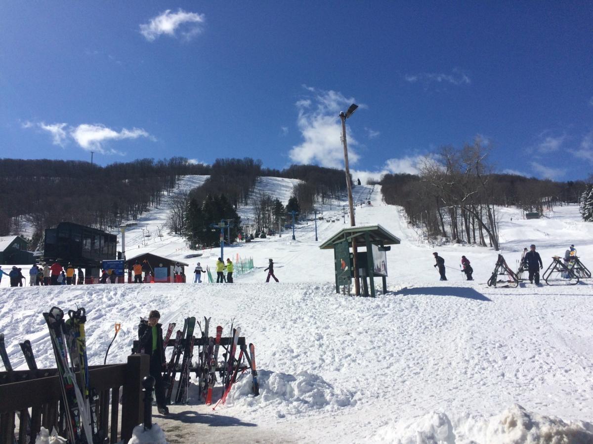 Hunt Hollow Ski Club in USA - a group of people skiing down a snowy hill.