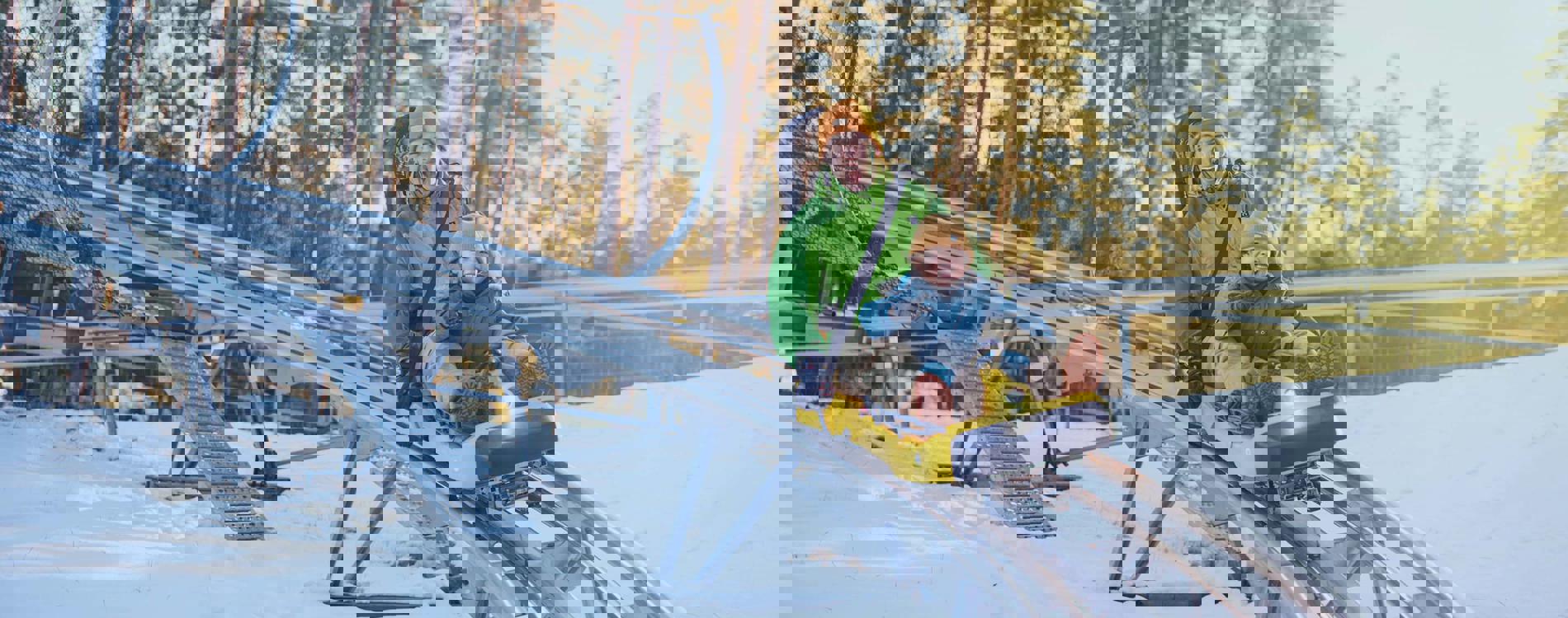 Isaberg Mountain Resort in Sweden - two people on a ski lift in the snow.