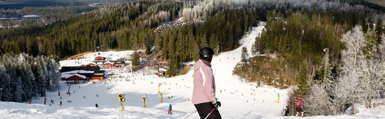Isaberg Mountain Resort in Sweden - a group of people skiing down a snowy slope.