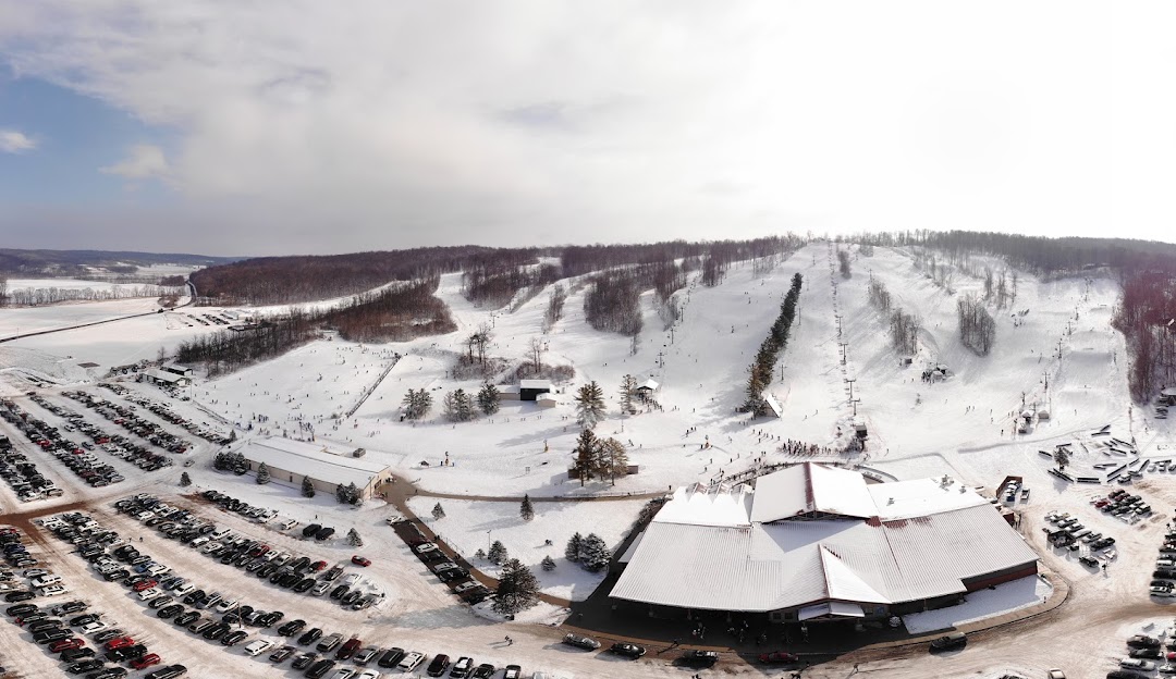 Winter sports enthusiasts enjoying at Mad River Mountain ski resort in Zanesfield, Ohio, USA amidst stunning snowy scenery.