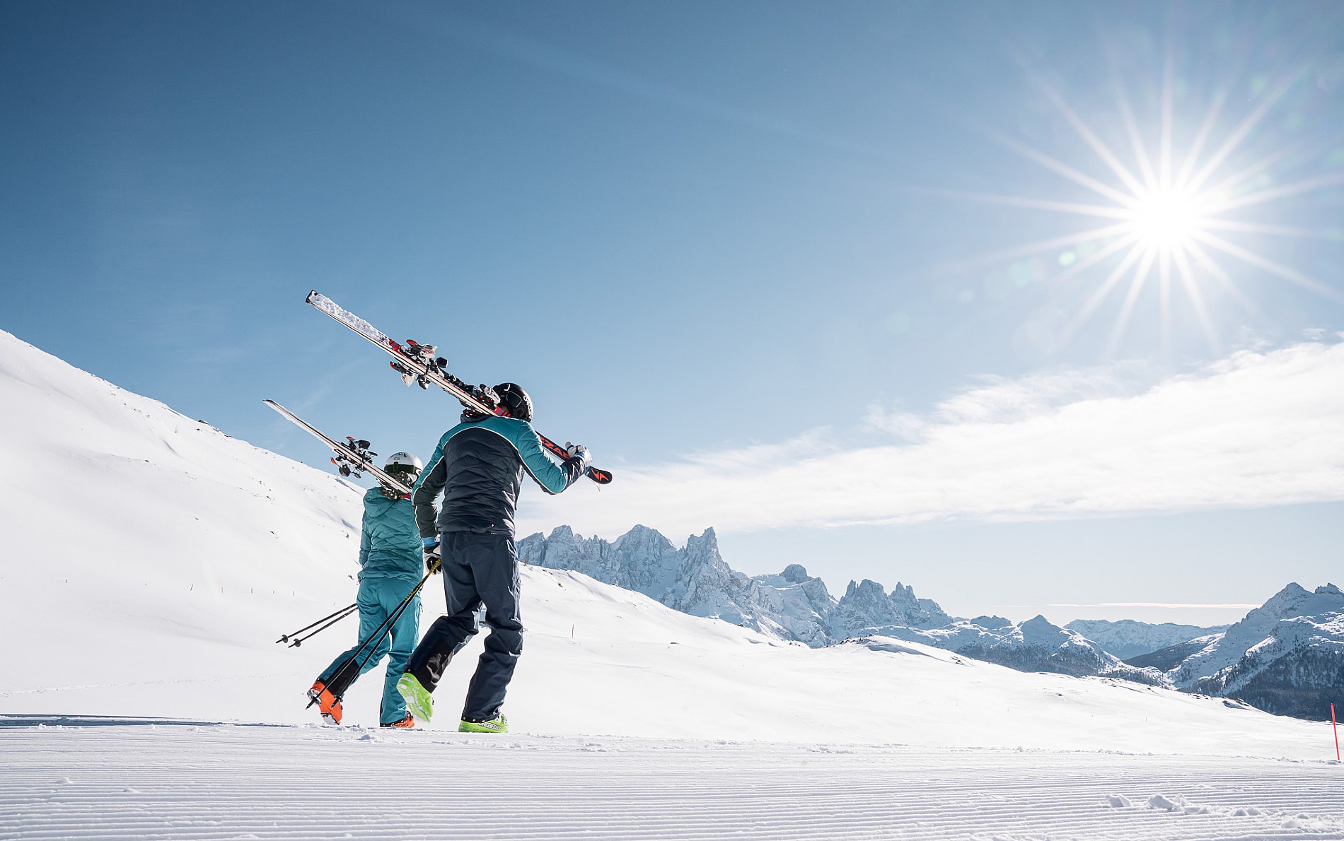 A vibrant winter sport scene at Alpe Lusia Trentino Italy showcasing an exuberant skier among a group of people likely a family enjoying skiing at the snowy resort.