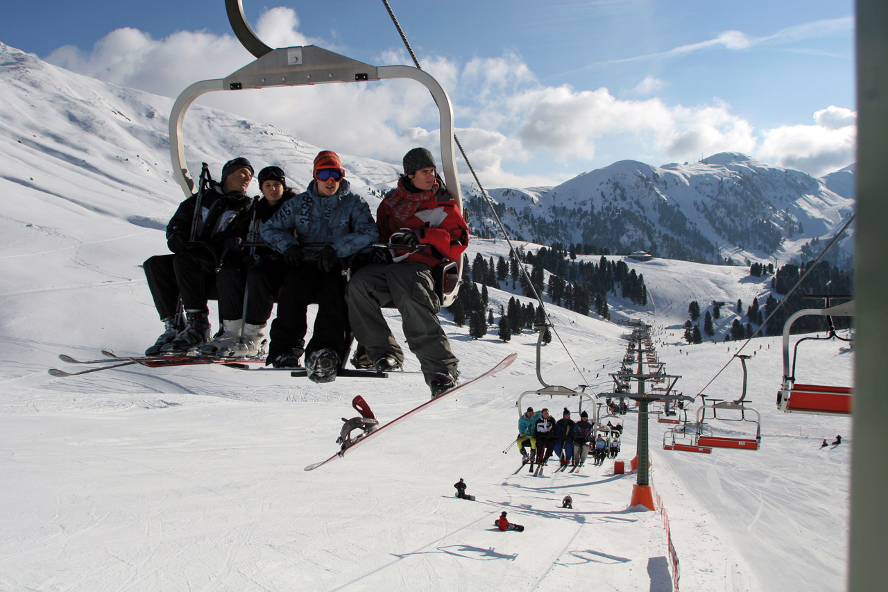 Alpe Lusia – Moena | Bellamonte in Italy - a group of people on a ski slope.