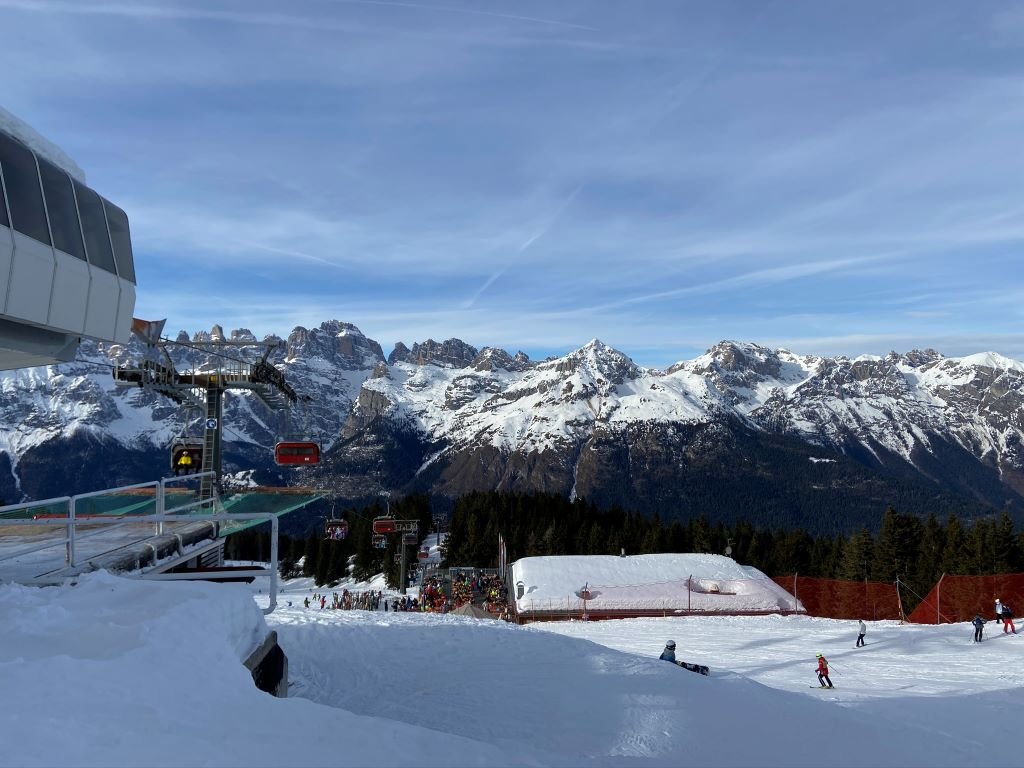 Alpe Lusia – Moena | Bellamonte in Italy - a ski lift going up a snowy mountain.