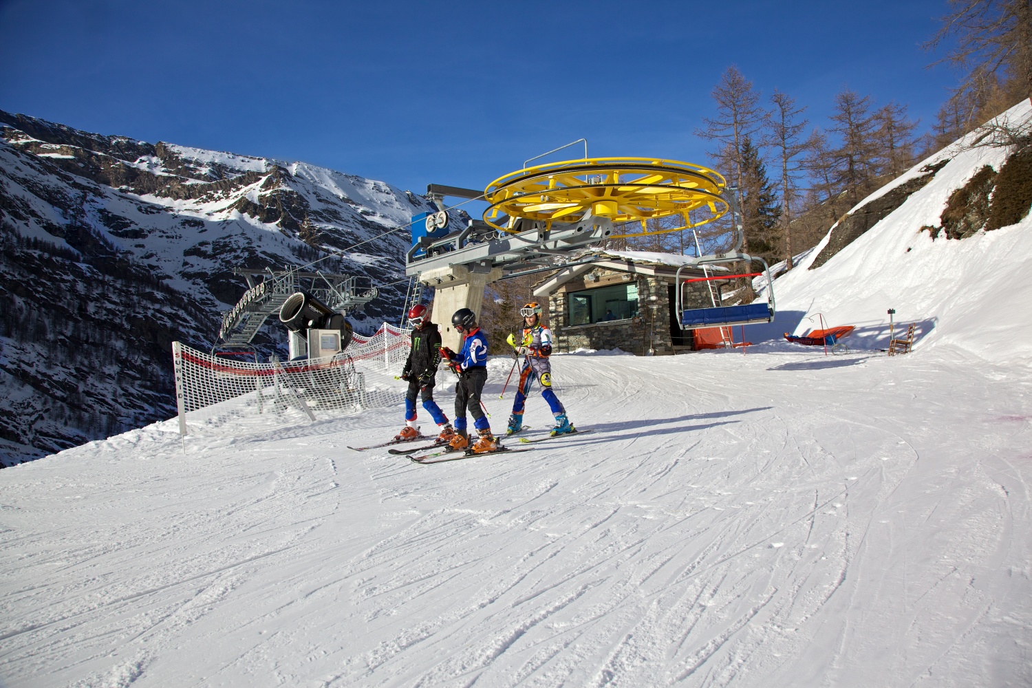 Valgrisenche in Italy - a group of people riding down a snow covered slope.