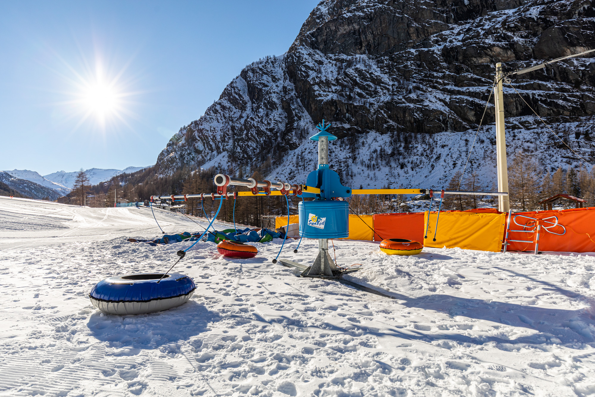 Winter sports scene in Valgrisenche, Gran Paradiso, Italy, featuring captivating snow-covered mountains and vast wintry landscapes ideal for skiing, with a picturesque ski resort subtly in the background.