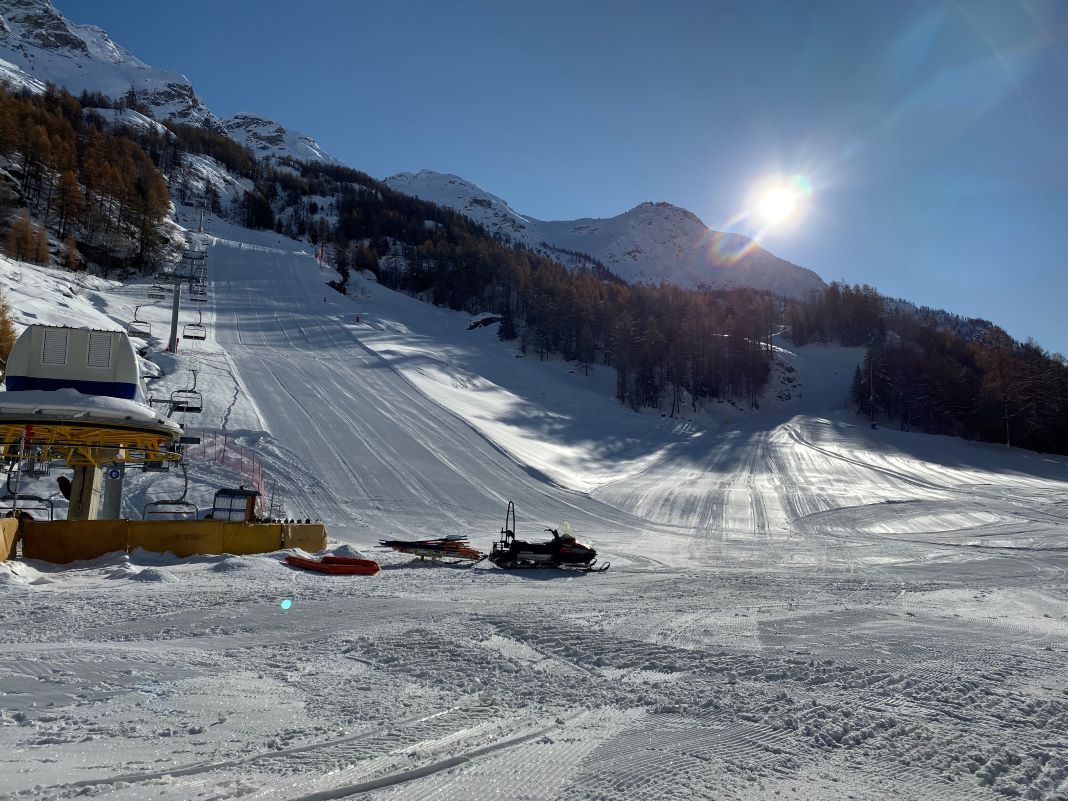 Winter sports enthusiasts enjoy a day on the slopes at Valgrisenche in Gran Paradiso, Aosta, Italy. A charming chalet and ski lift are nearby in this picturesque ski resort.