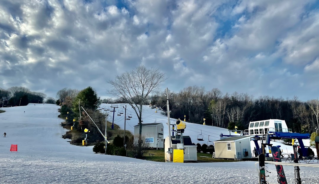 Photo capturing a lively winter sports scene at Mt Southington in Plantsville Connecticut USA. The winter scenery includes a bustling ski resort and stunning snow-covered landscape.