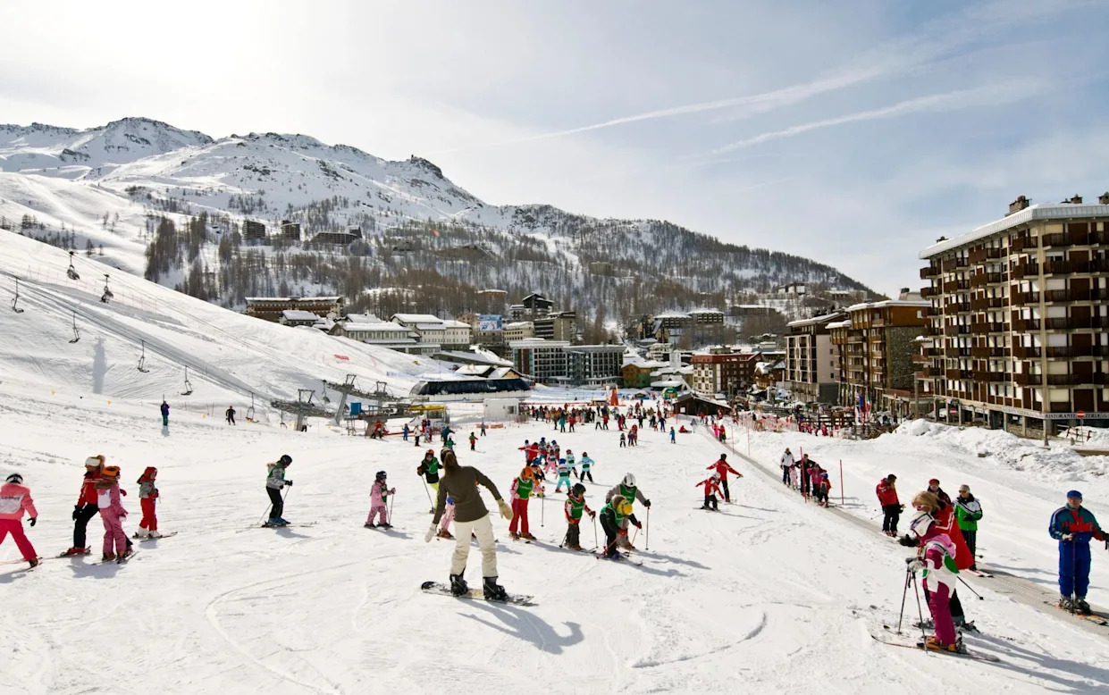 Osa in Japan - a group of people skiing down a snow covered slope.