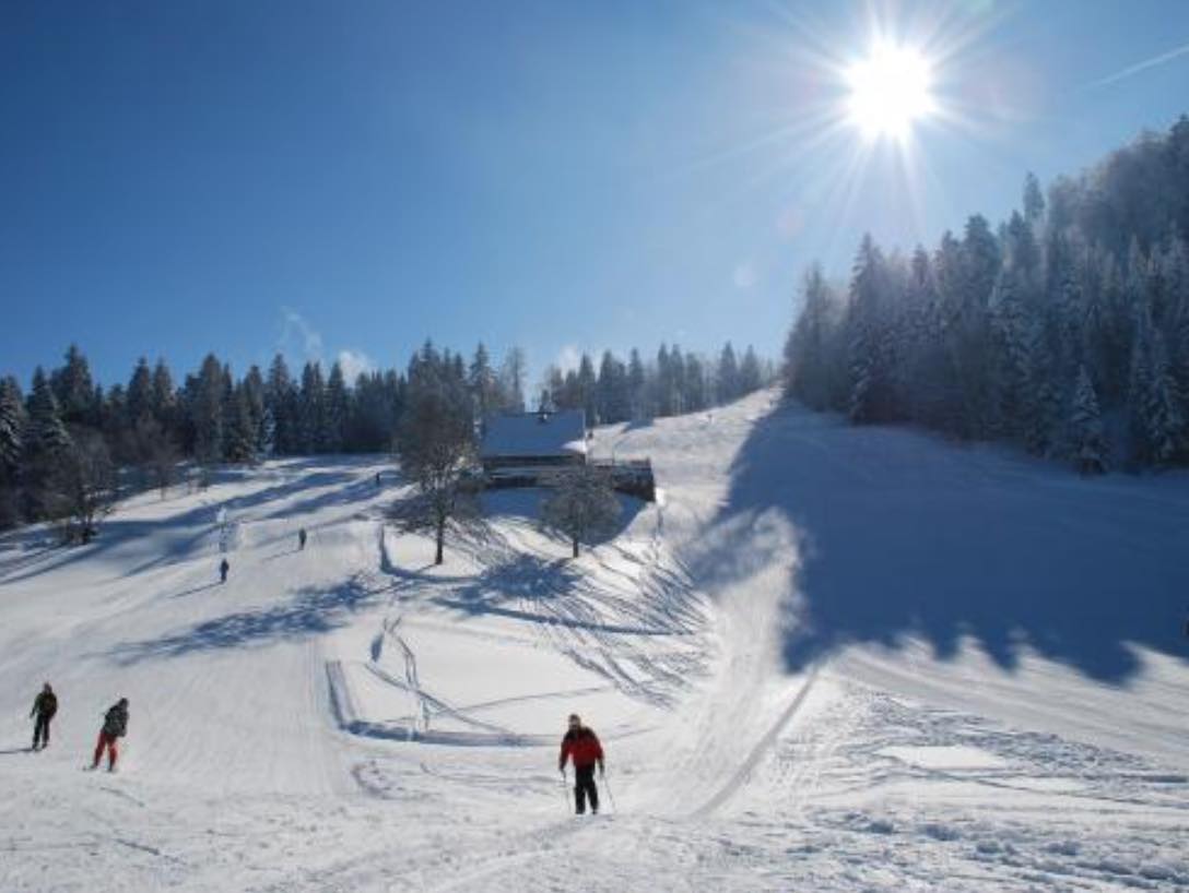 Ventron in France - a group of people skiing down a snow covered slope.