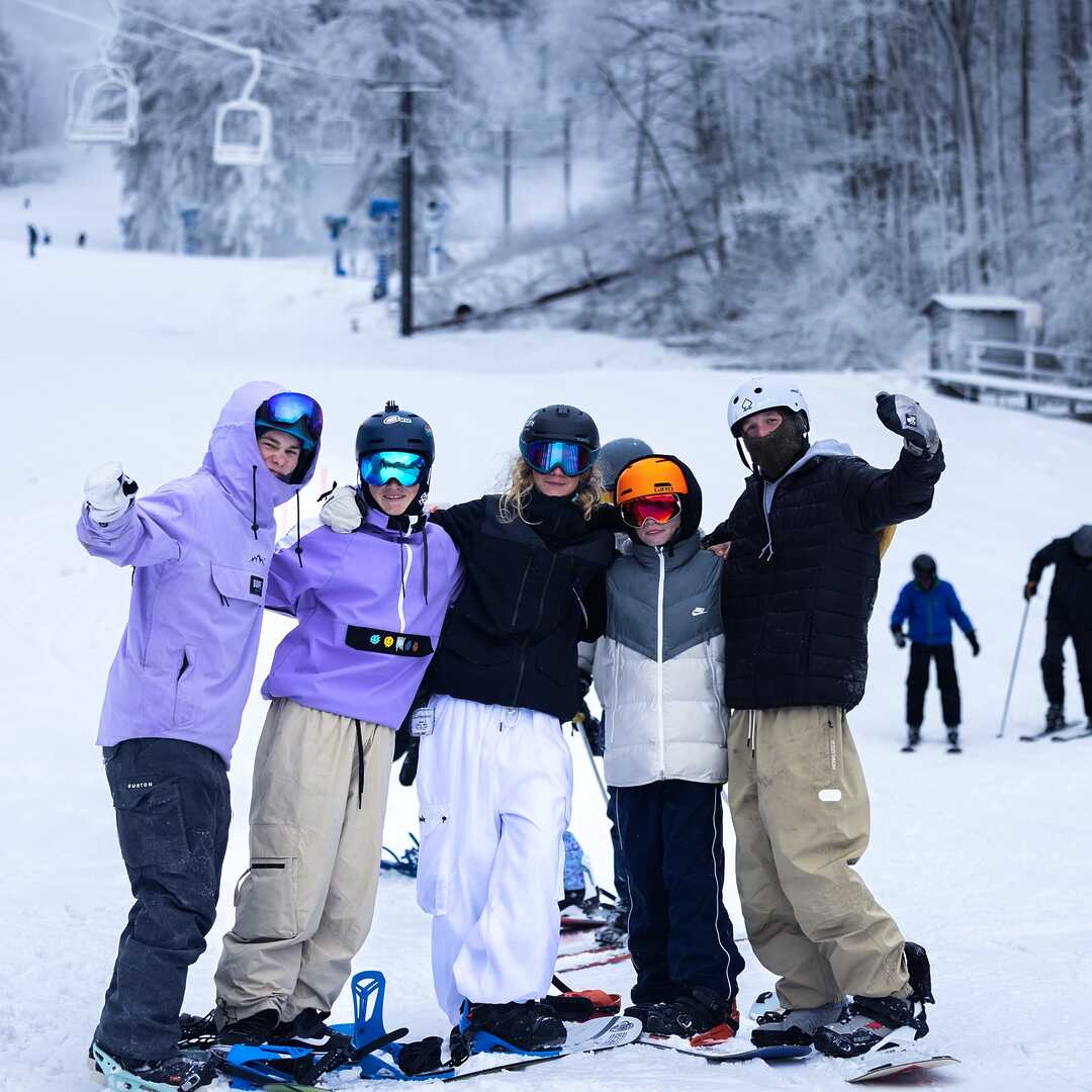Hatley Pointe in USA - a group of people standing on a snow covered hill.