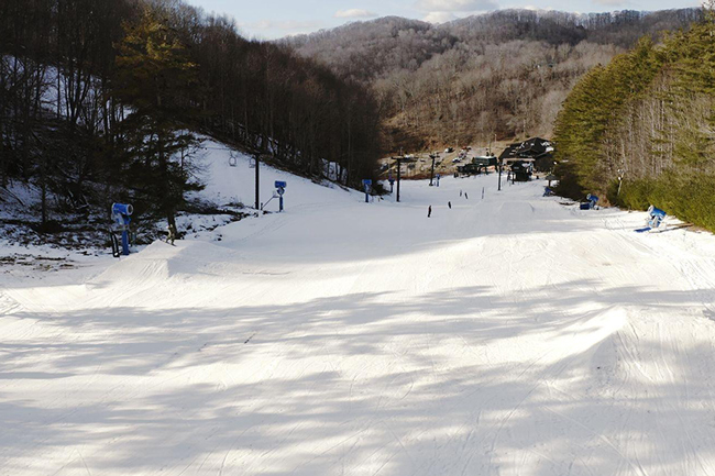 A skier enjoying a day at Hatley Pointe, a popular ski resort in Mars Hill, North Carolina. The image features snow-covered slopes indicative of a winter sports scene.