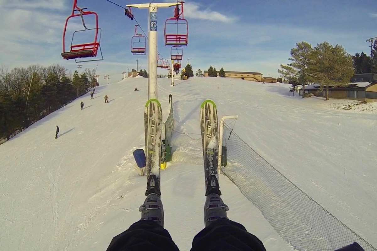 Sundown in USA - a person riding a ski board down a snowy slope.
