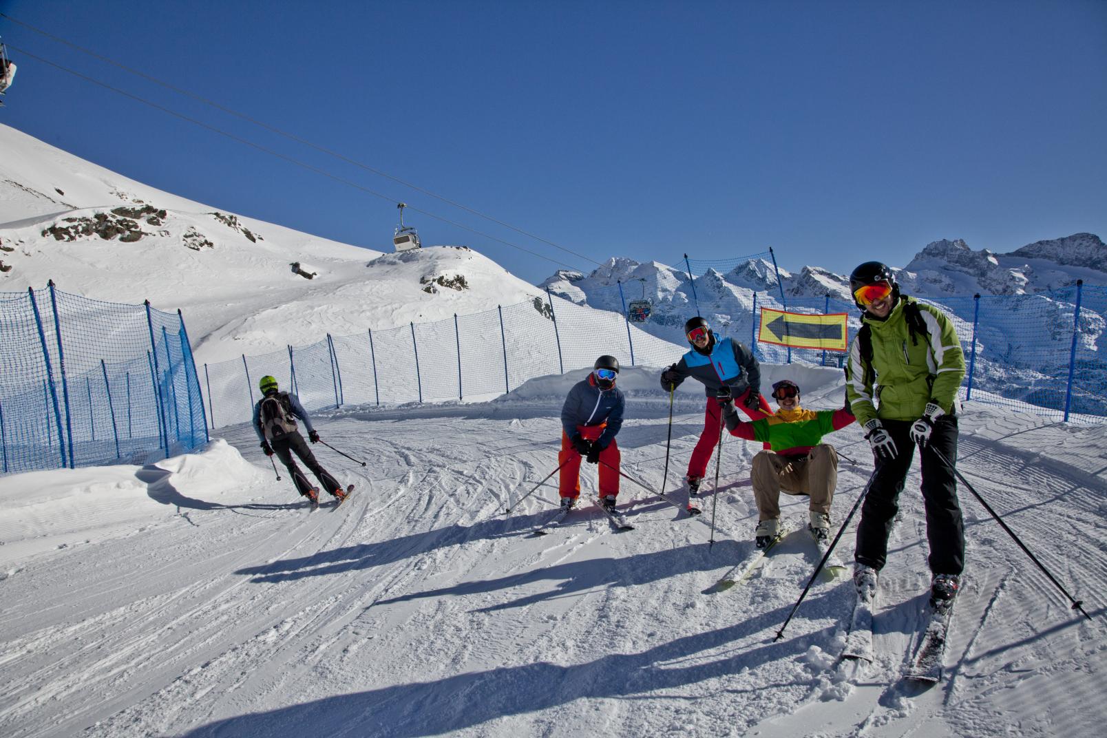 Alagna Valsesia | Gressoney-La-Trinité | Champoluc | Frachey in Italy - a group of people skiing down a snowy slope.