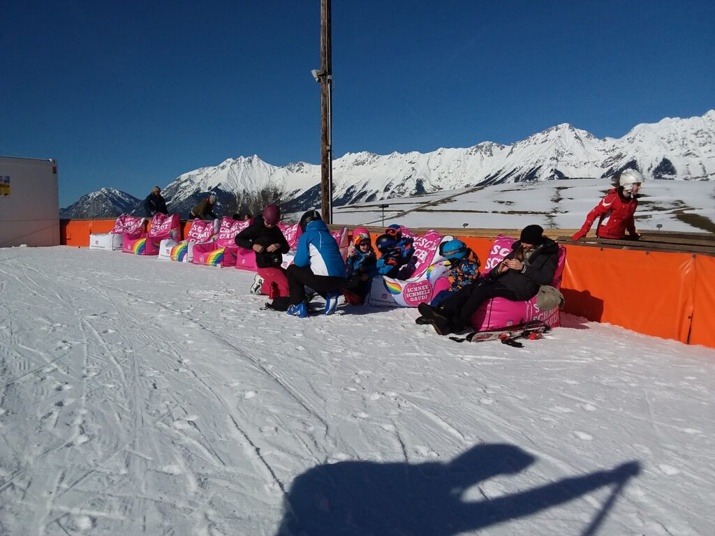 Archenstadel – Rinn in Austria - a group of people sitting in the snow.