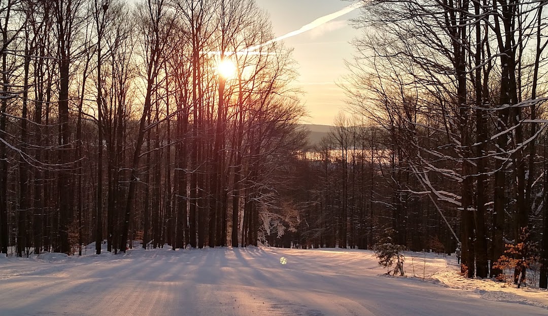 Winter sports scene at Mount Pleasant of Edinboro in Cambridge Springs, Pennsylvania. It features stunning winter scenery with snow-covered slopes and a chalet. There's also a winter sports center.