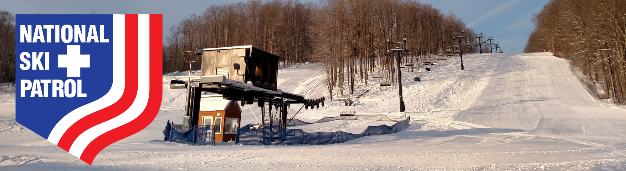 Mount Pleasant of Edinboro in USA - the national ski patrol logo on a ski slope.