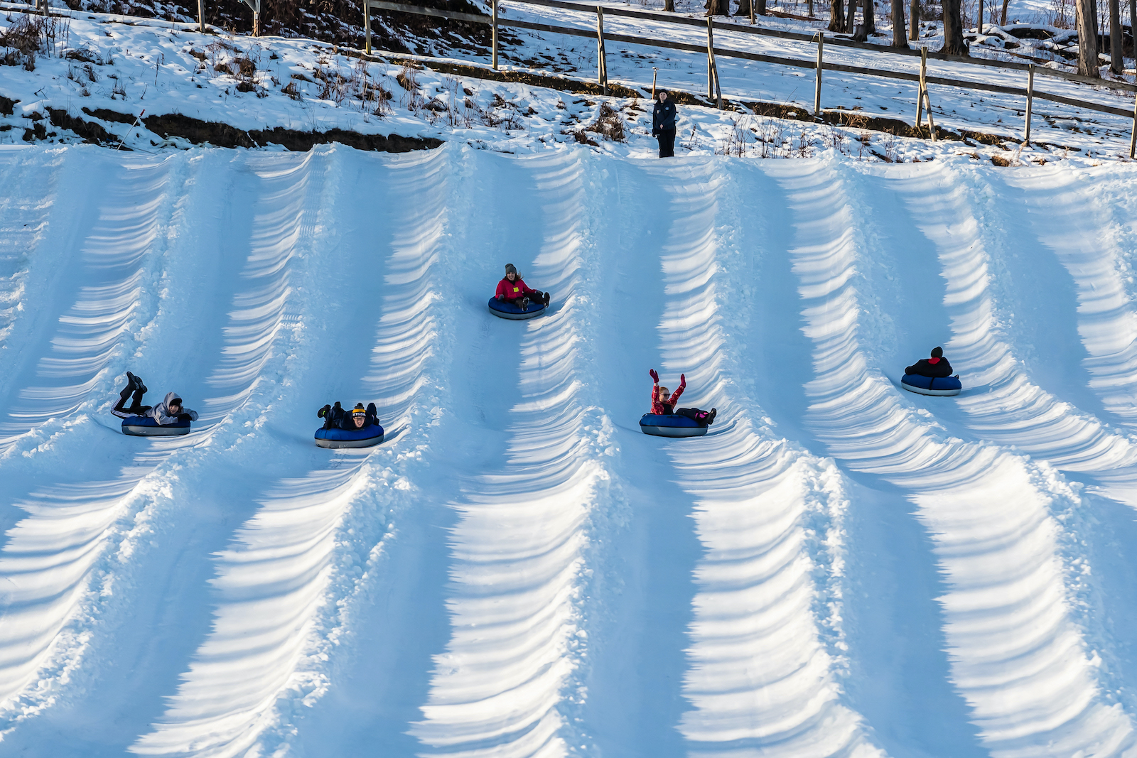 Mount Pleasant of Edinboro in USA - a group of people riding down a snow covered hill.