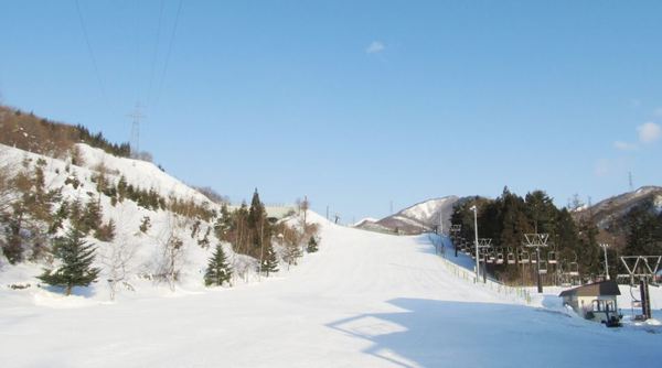 A stunning winter scene at St Mary in Tohoku, Japan, featuring a lively ski resort and sports centre nestled amidst a beautiful snowy landscape, complete with a charming chalet.