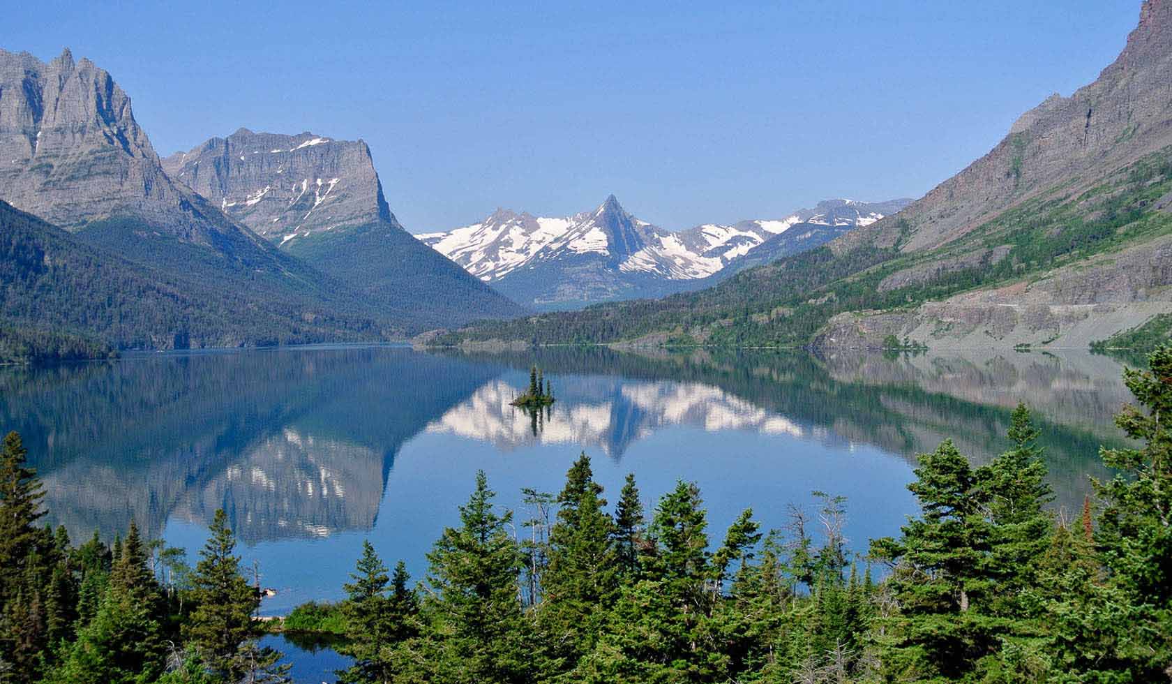 St Mary in Japan - a view of a mountain lake surrounded by pine trees.
