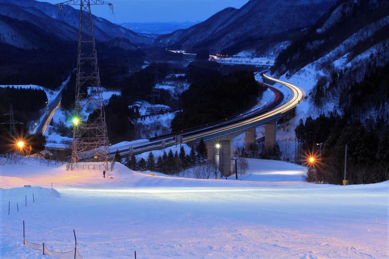 A picturesque winter scene at St Mary in Tōhoku, Japan showcasing a lively ski resort surrounded by chalets. The serene winter backdrop adds to the allure of this popular winter sports destination.