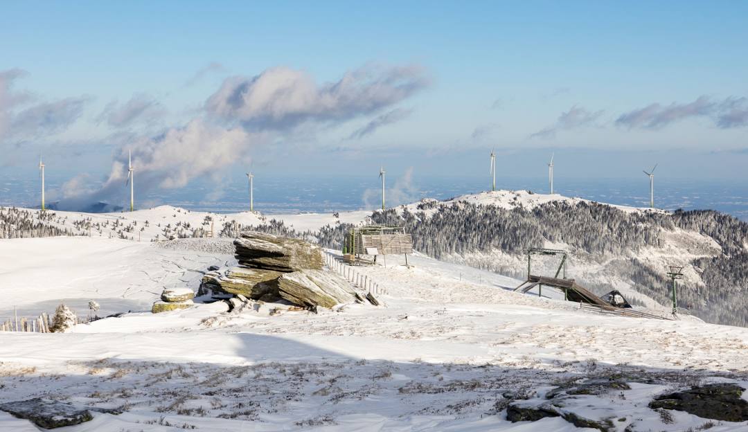 Image depicting a lively winter sports scene at Weinebene Lower Carinthia Austria featuring a winter sports centre amidst stunning snow-covered winter scenery showcasing a busy ski resort.