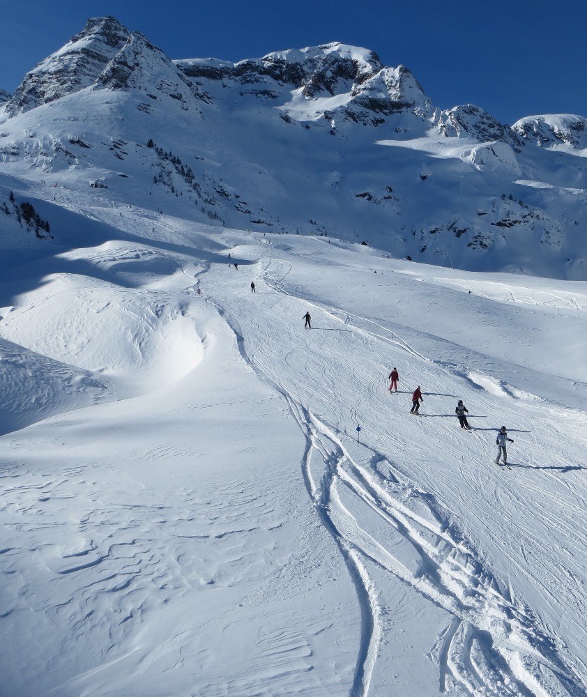 Formigal in Spain - a group of people skiing down a snow covered mountain.