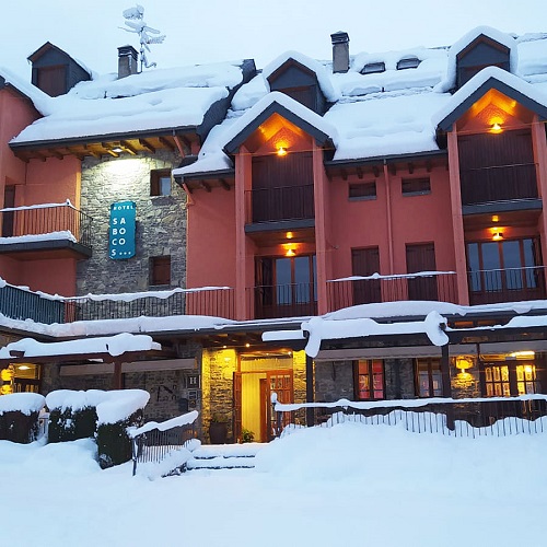 Formigal in Spain: a building covered in snow with lights on.