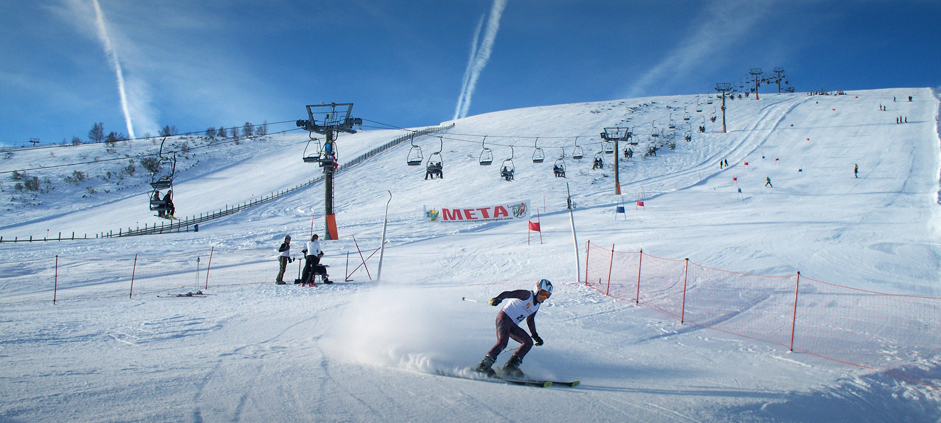 Leitariegos in Spain - a person is skiing down a snowy hill.