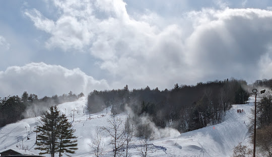 Picture showcasing a bustling winter sports scene at Vorlage ski resort in Wakefield, Quebec, Canada. Stunning winter scenery filled with snow-covered slopes are visible, creating a captivating view.