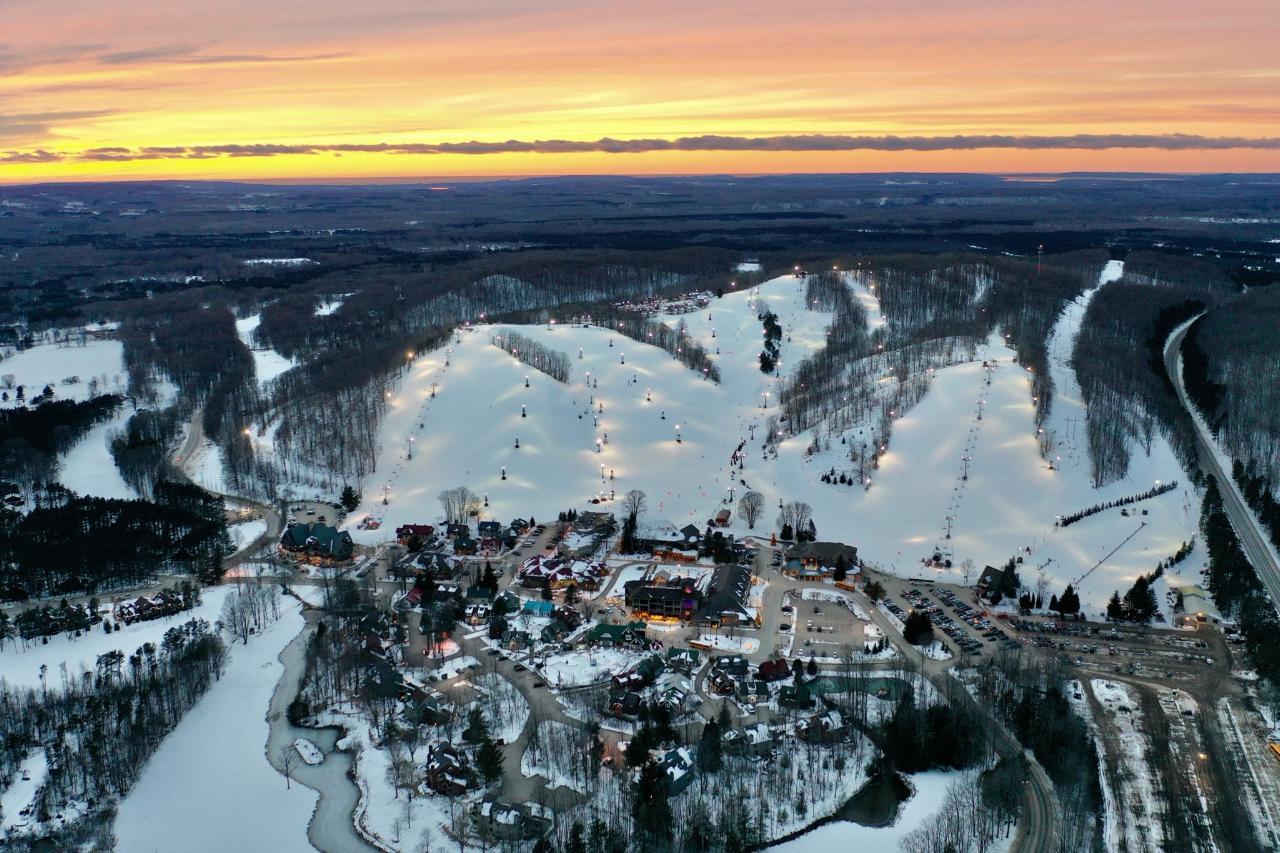 Crystal Mountain - MI in USA: an aerial view of a ski resort at sunset.