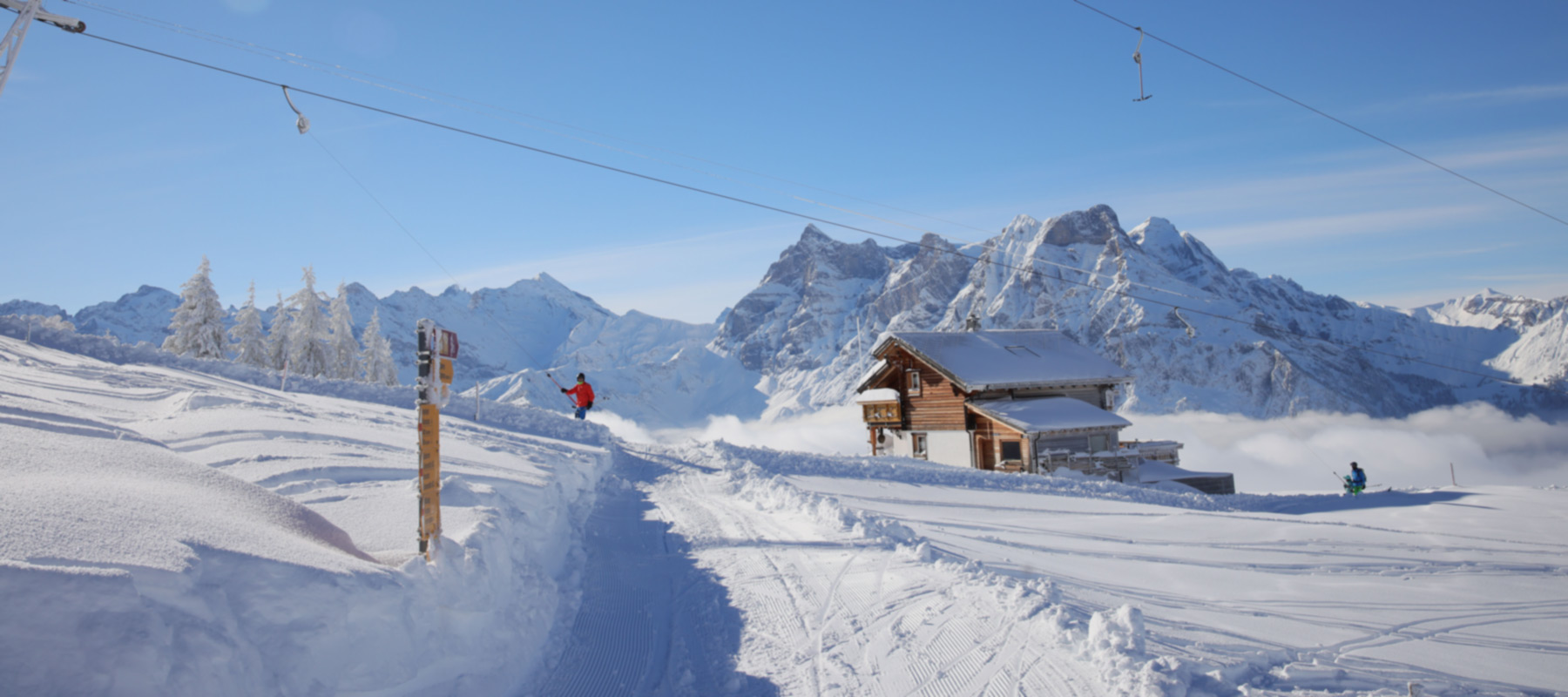 Winter sports enthusiasts enjoy a day at Eggberge ski resort nestled in Uri, Reuss Valley, Altdorf, Central Switzerland, featuring a cozy chalet and surrounding wintry scenery.