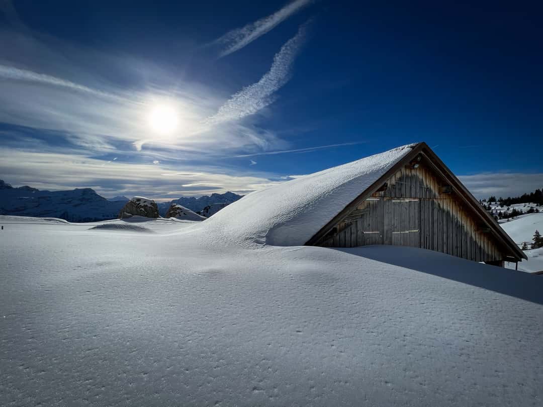 Eggberge in Switzerland - a house in the middle of a snow covered field.