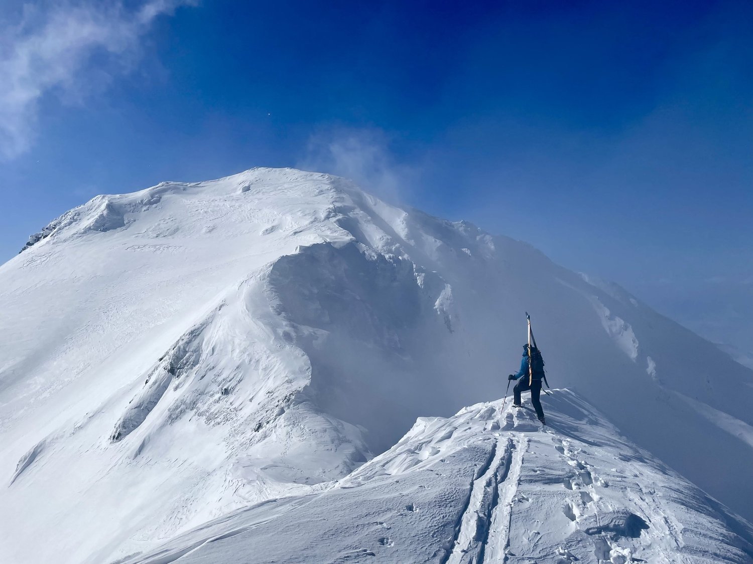 Asahidake in Japan - a person standing on top of a snow covered mountain.