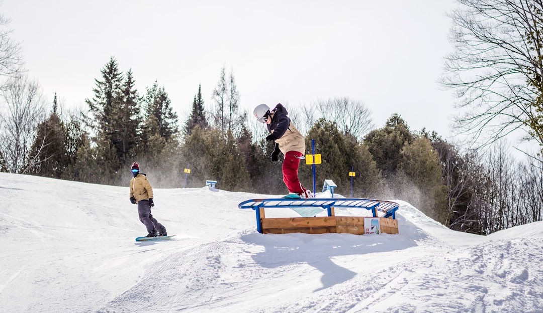 A snowboarder tackling the snowy slopes at Sir Sam's ski resort in Eagle Lake Ontario Canada.
