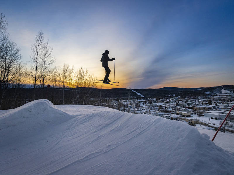 La Tuque in Canada - a person jumping in the air on a snowboard.