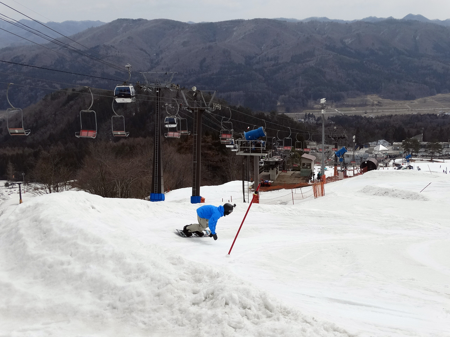 Okutone Snow Park in Japan - a person on a snowboard in the snow.