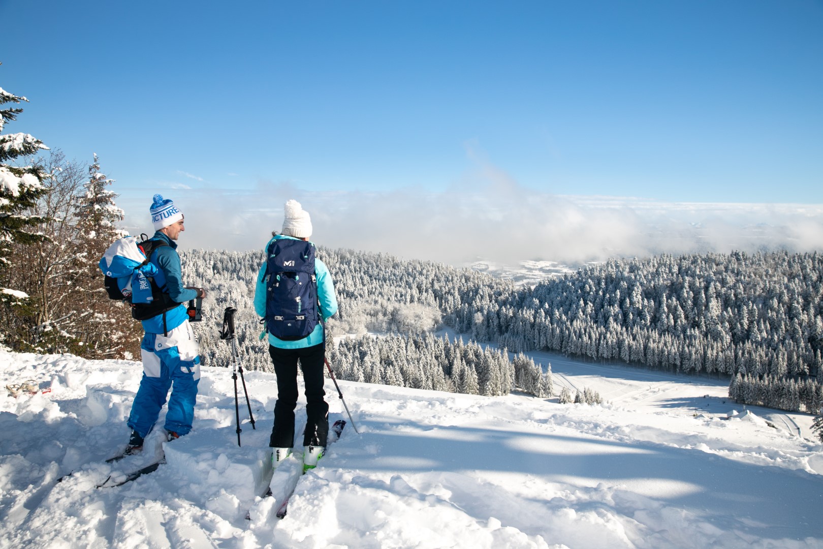 A family enjoying skiing in a winter sports scene at Terre-Ronde Ain Plateau d'Hauteville Auvergne-Rhône-Alpes France amid a beautiful winter landscape.