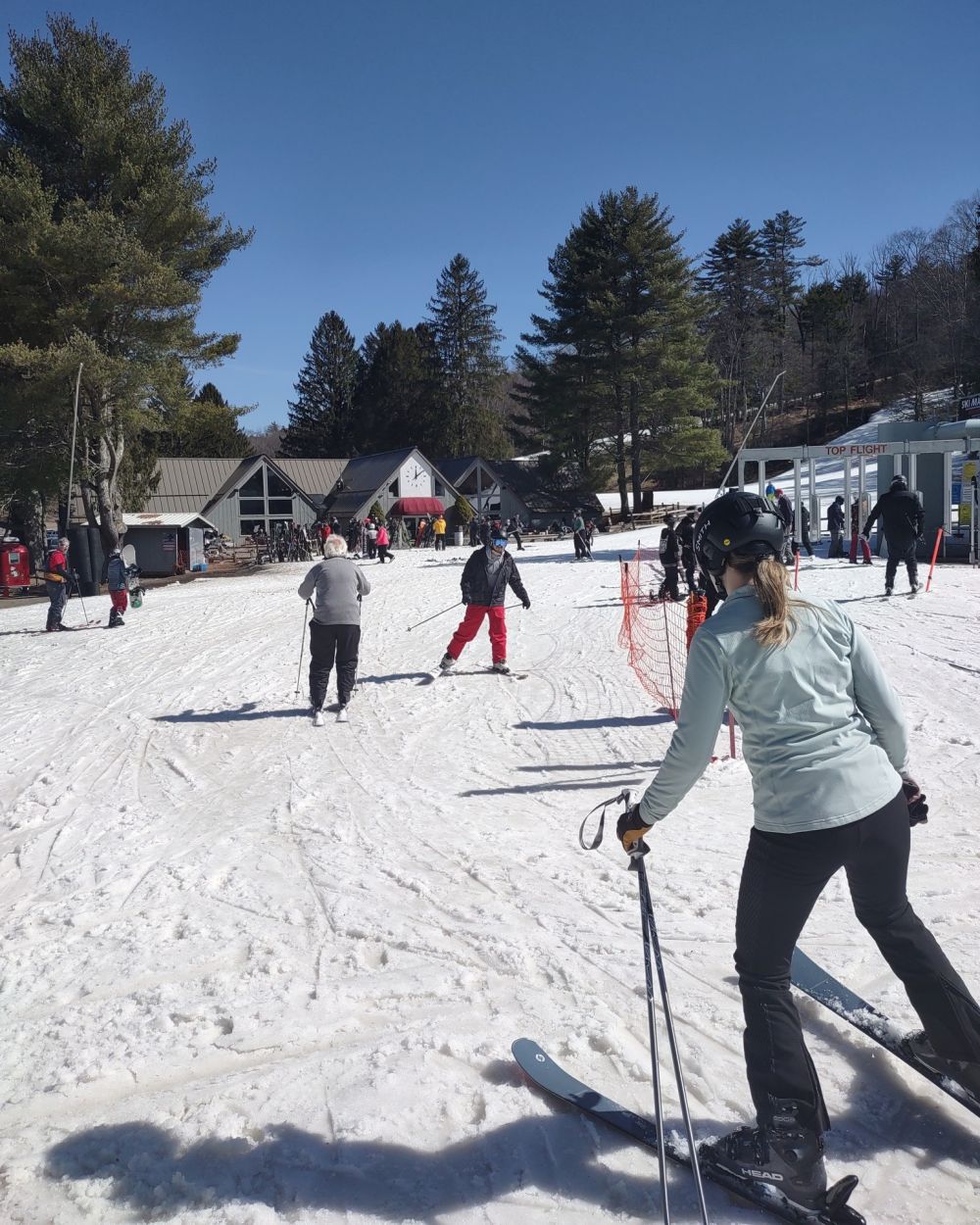 Nashoba Valley Ski Area in USA - a group of people skiing down a snow covered slope.