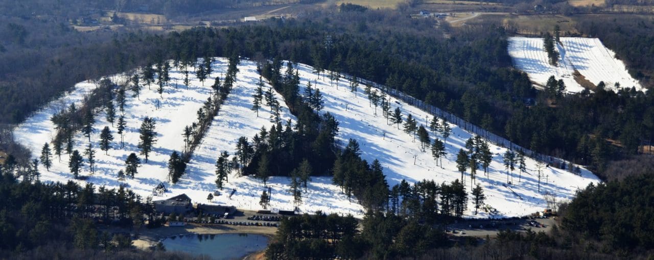 View of Nashoba Valley Ski Area in Westford, Massachusetts featuring a bustling winter sport scene with snow-covered slopes and a stunning winter landscape.