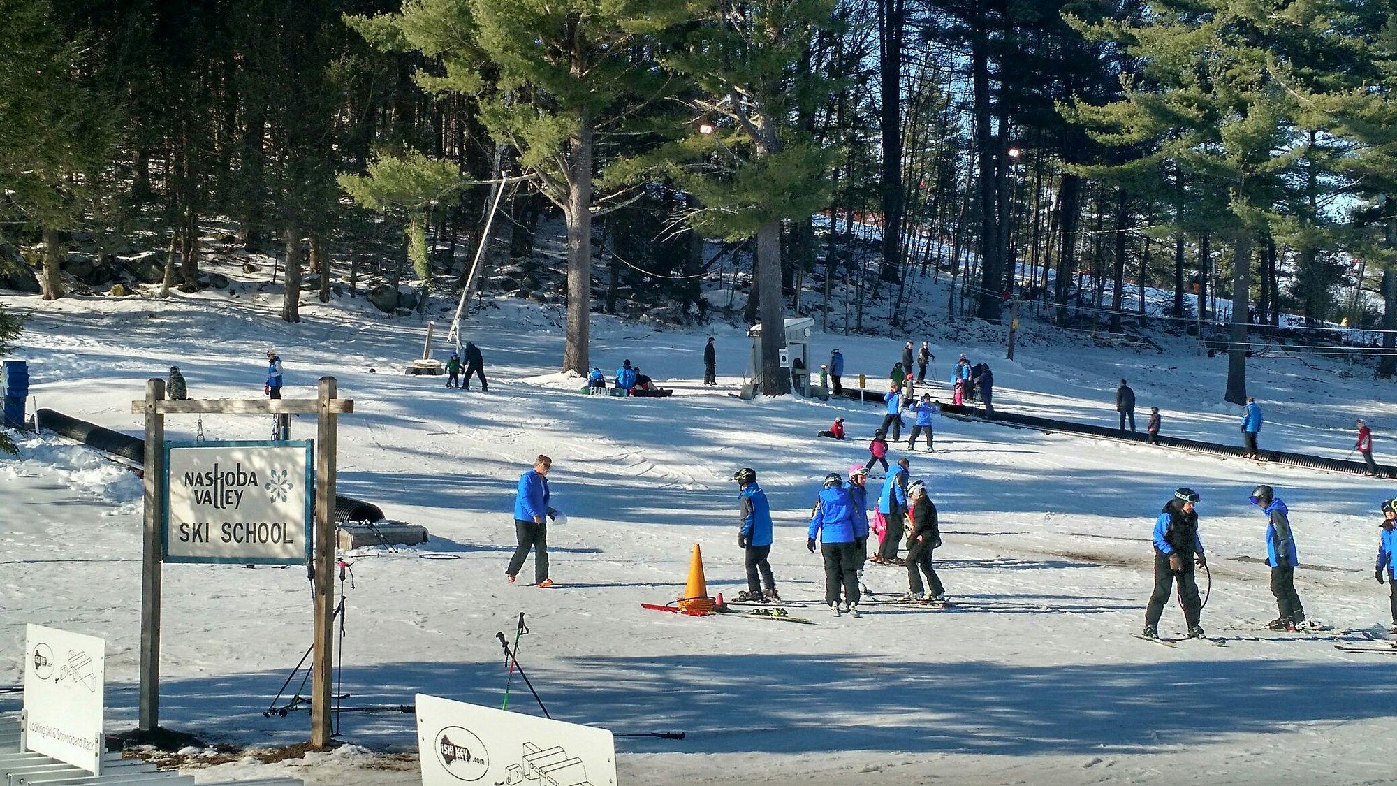 Winter sport enthusiasts skiing down the snow-covered slopes at Nashoba Valley Ski Area in Westford, Massachusetts.