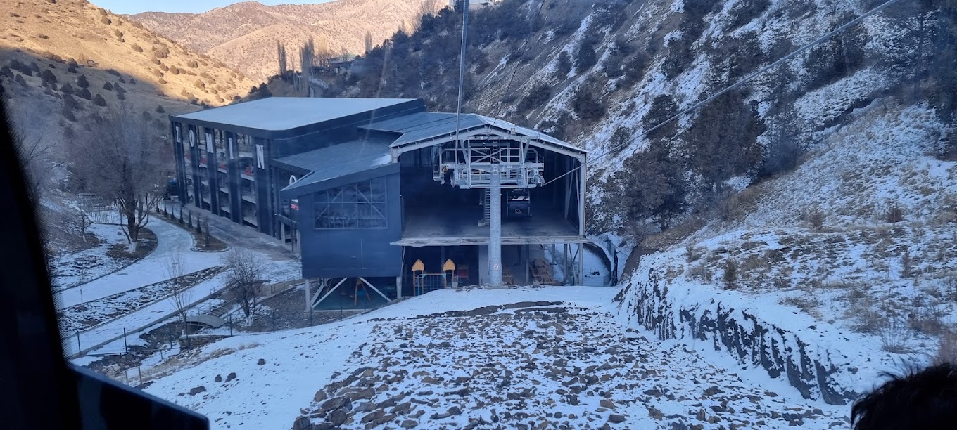 Ski resort at Zomin Ropeway in Uzbekistan featuring a ski lift amidst a stunning winter landscape, indicative of a hub for winter sports.
