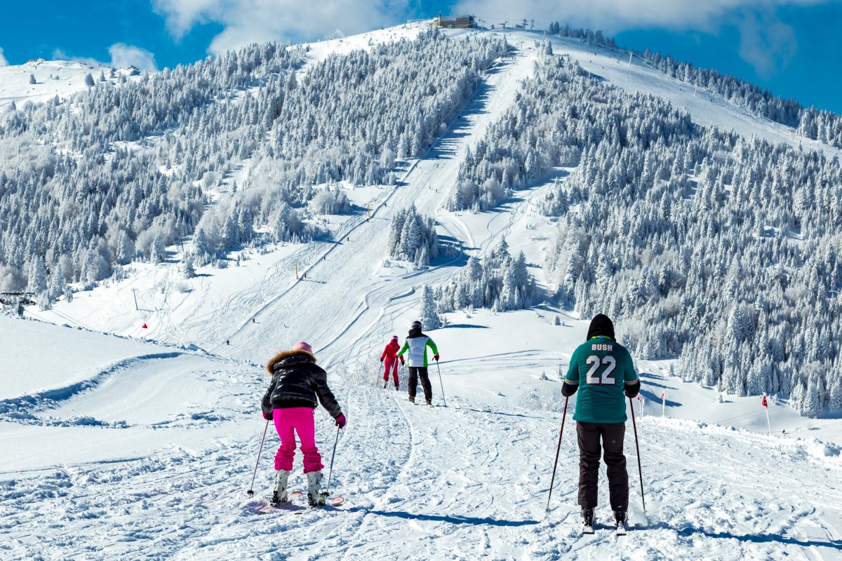 Bolkar Kayak Merkezi in Turkey - a group of people skiing down a snowy slope.