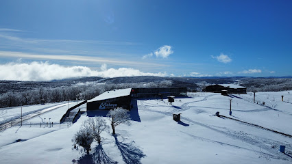 Winter sports center at Selwyn Snowfields in Kiandra, New South Wales, Australia, featuring a scenic snowy landscape with a chalet and a ski resort.