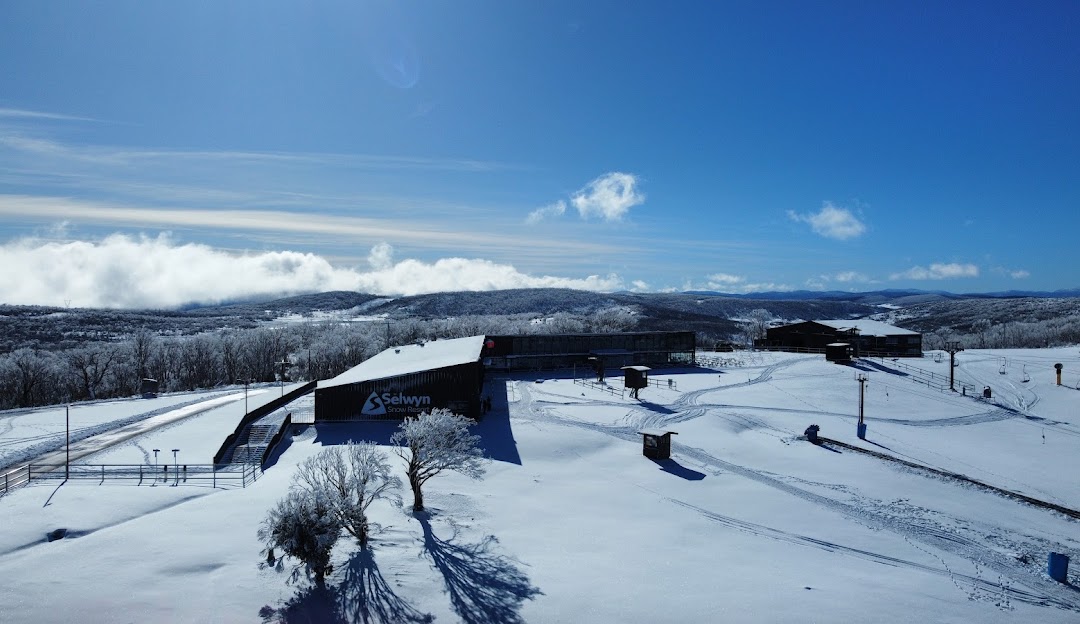 Winter sports scene at Selwyn Snowfields Kiandra displaying a charming chalet amidst stunning winter scenery highlighting a popular winter sports centre in Australia.